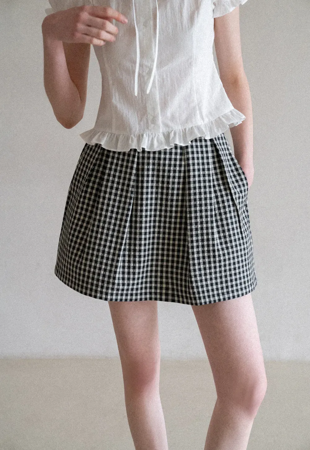 Plaid skirt with pleats and ruffled top