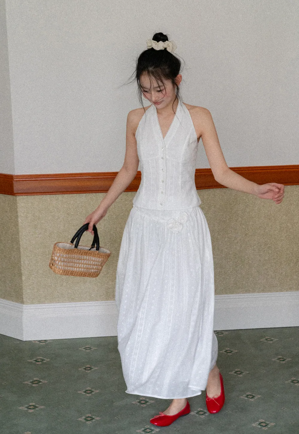 Halter neck sleeveless top with buttons and pleated skirt