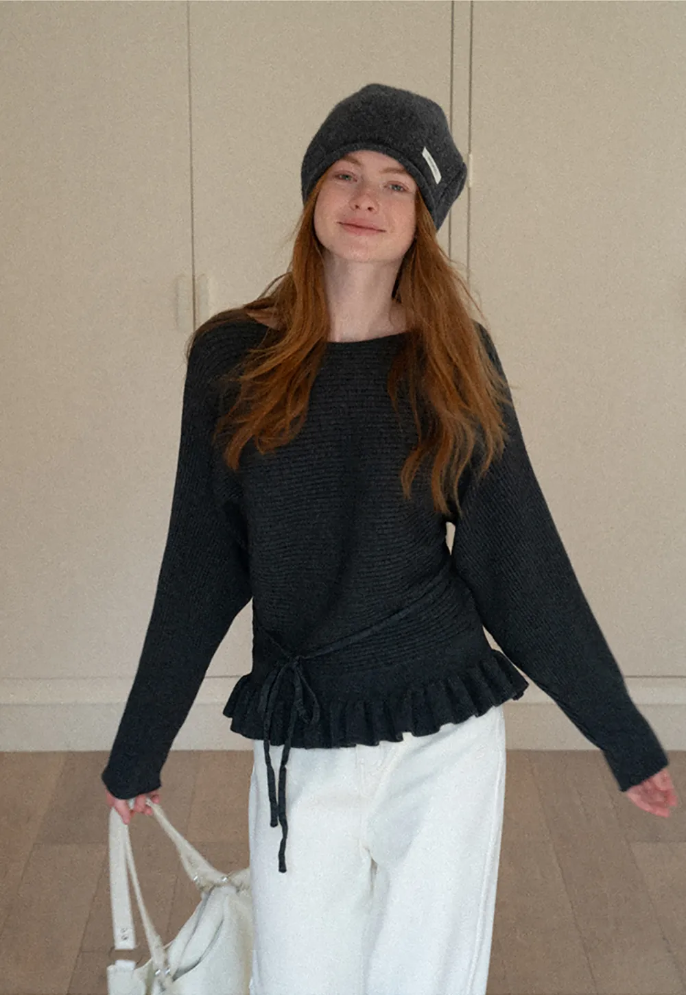 Ribbed knit sweater with tie back and flared hem design