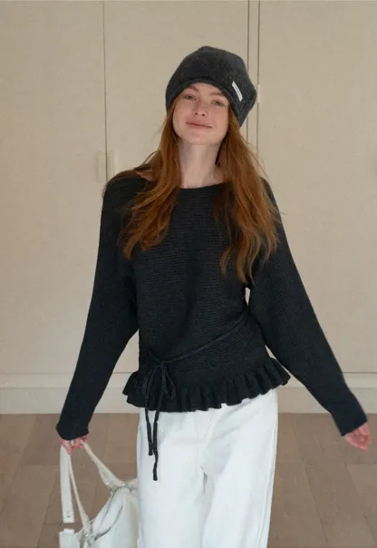 Ribbed knit sweater with tie back and flared hem design