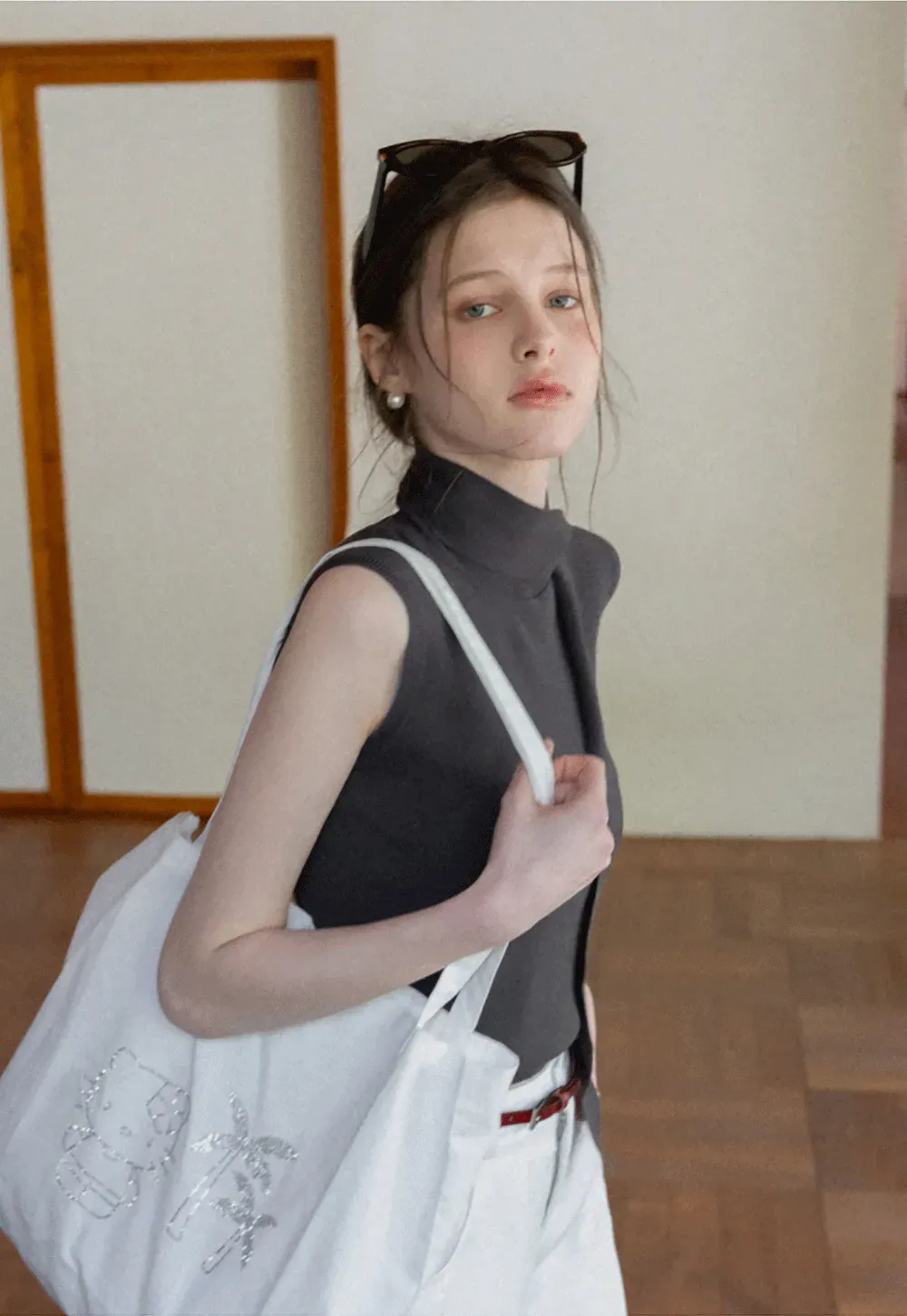 Sleeveless high neck knit top with side tie detail