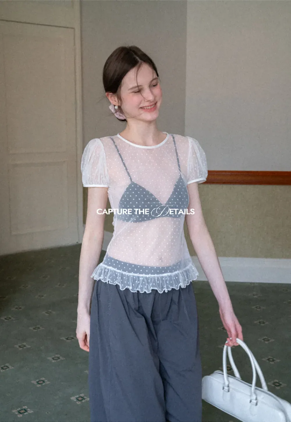 Sheer polka dot top with ruffled hem and puff sleeves