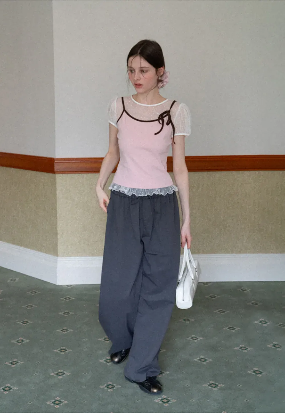 Sheer polka dot top with ruffled hem and puff sleeves