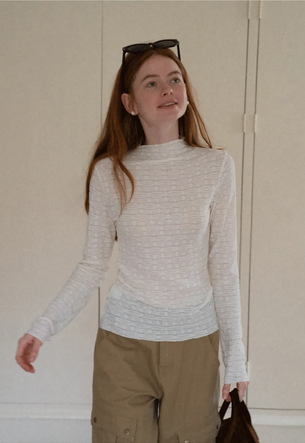 Elegant textured long sleeve top with subtle pattern design