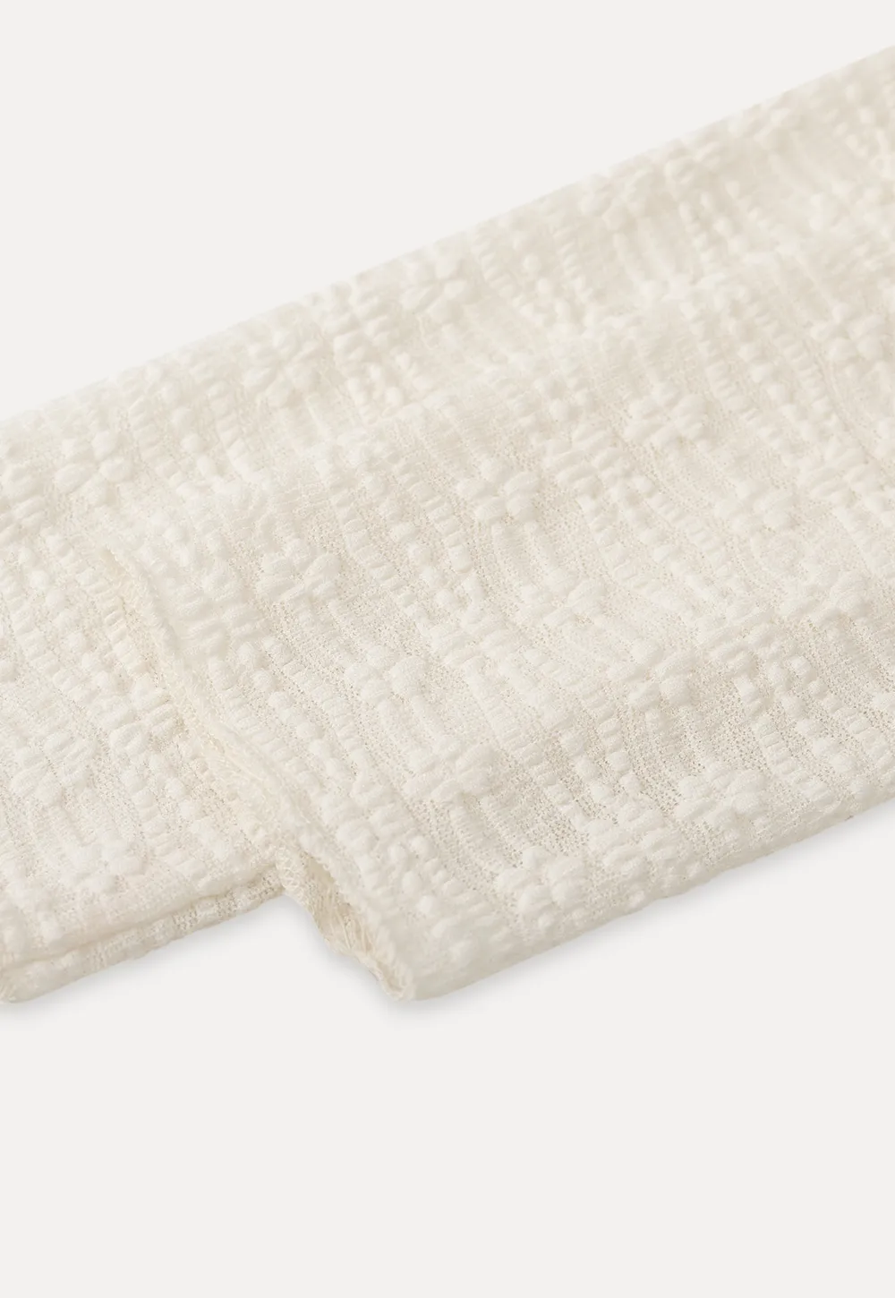 Elegant textured long sleeve top with subtle pattern design