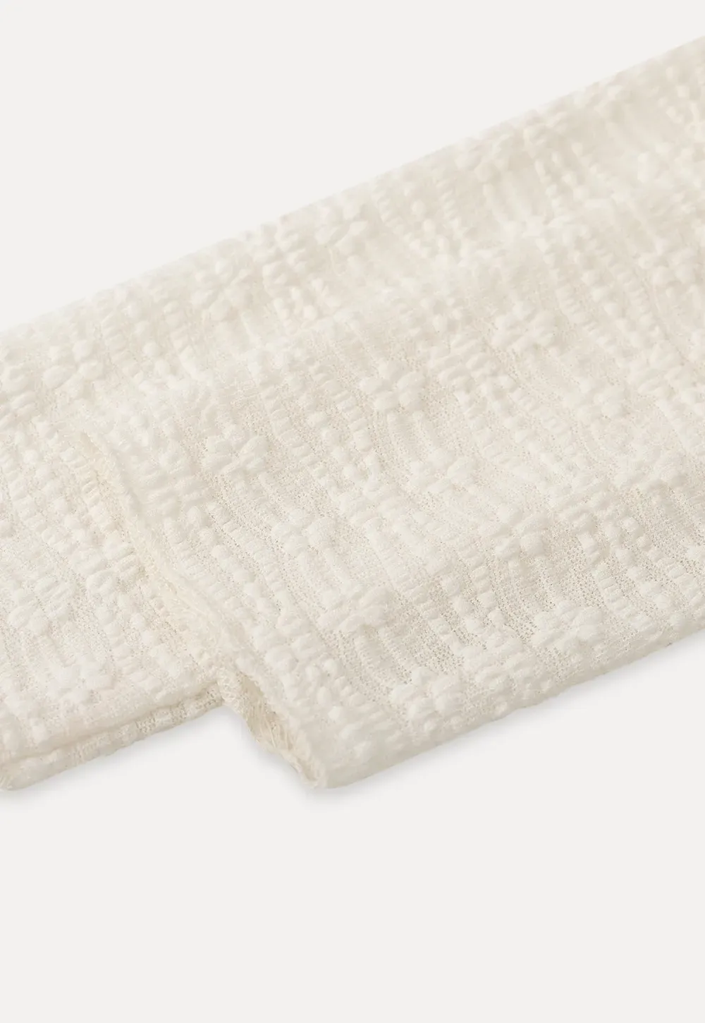 Elegant textured long sleeve top with subtle pattern design