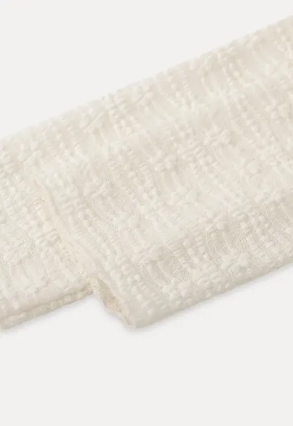 Elegant textured long sleeve top with subtle pattern design