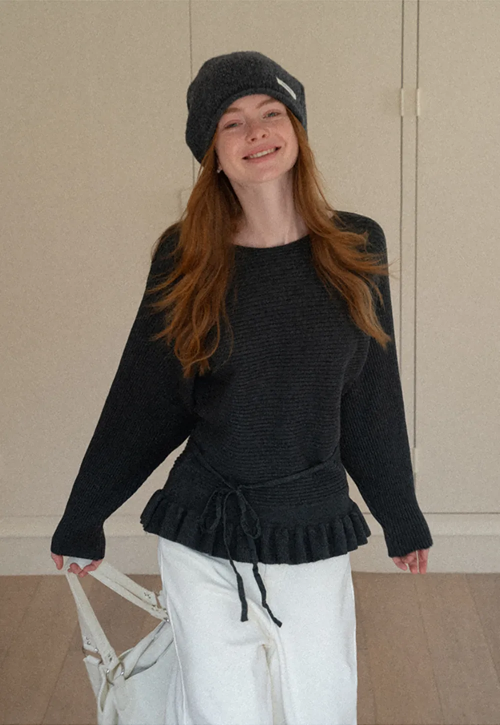 Ribbed knit sweater with tie back and flared hem design