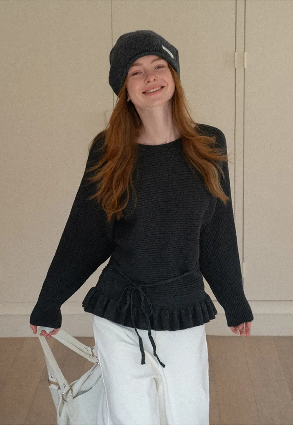 Ribbed knit sweater with tie back and flared hem design