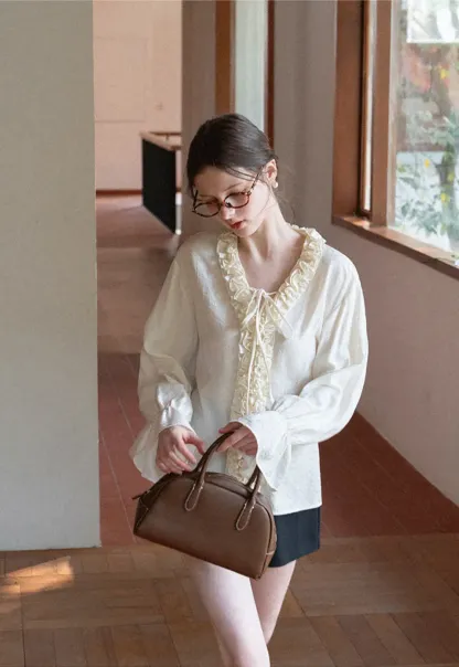 Long sleeve shirt with ruffled neckline and gathered cuffs