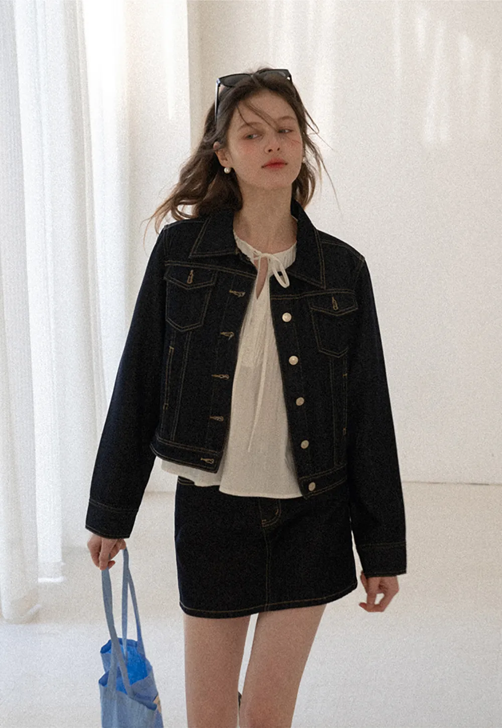 A-line denim skirt with front pocket design and adjustable waistband.