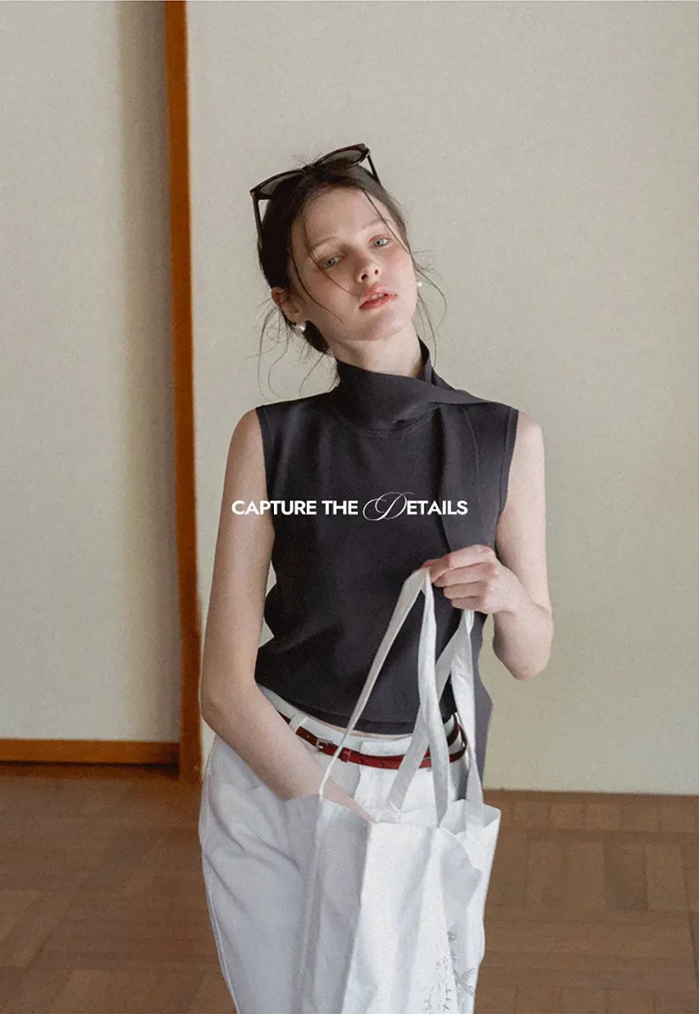 Sleeveless high neck knit top with side tie detail