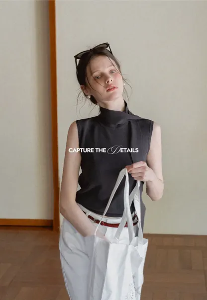 Sleeveless high neck knit top with side tie detail