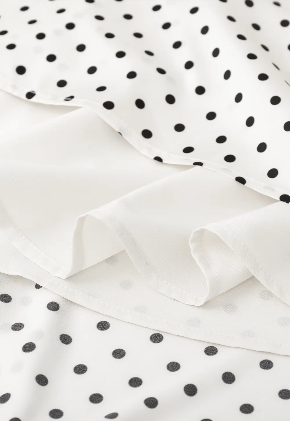 Polka dot asymmetrical hem skirt with pleats