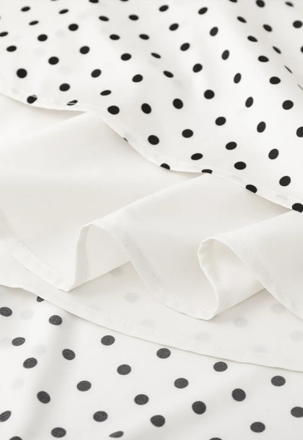 Polka dot asymmetrical hem skirt with pleats