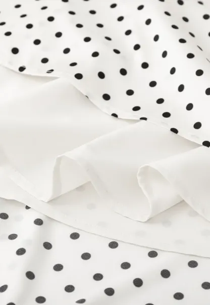 Polka dot asymmetrical hem skirt with pleats