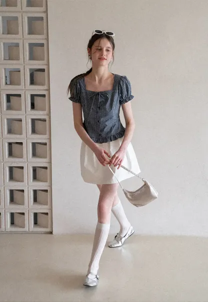 Plaid skirt with pleats and ruffled top