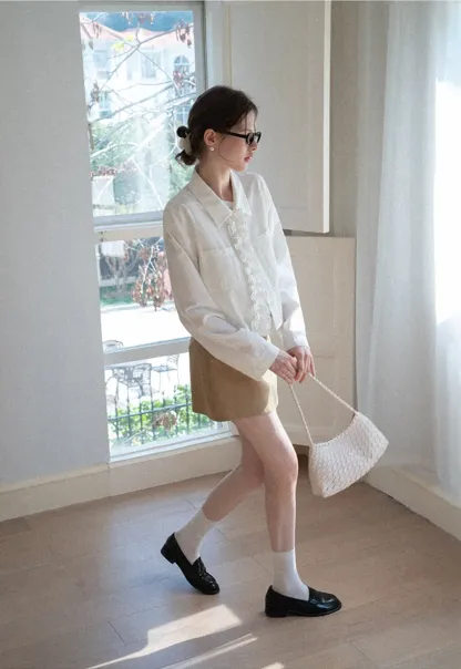 Short jacket with ruffled front placket and collar