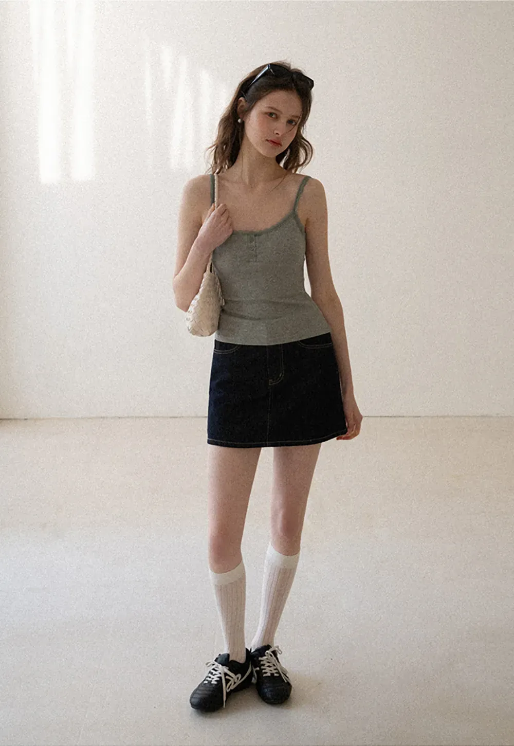 A-line denim skirt with front pocket design and adjustable waistband.