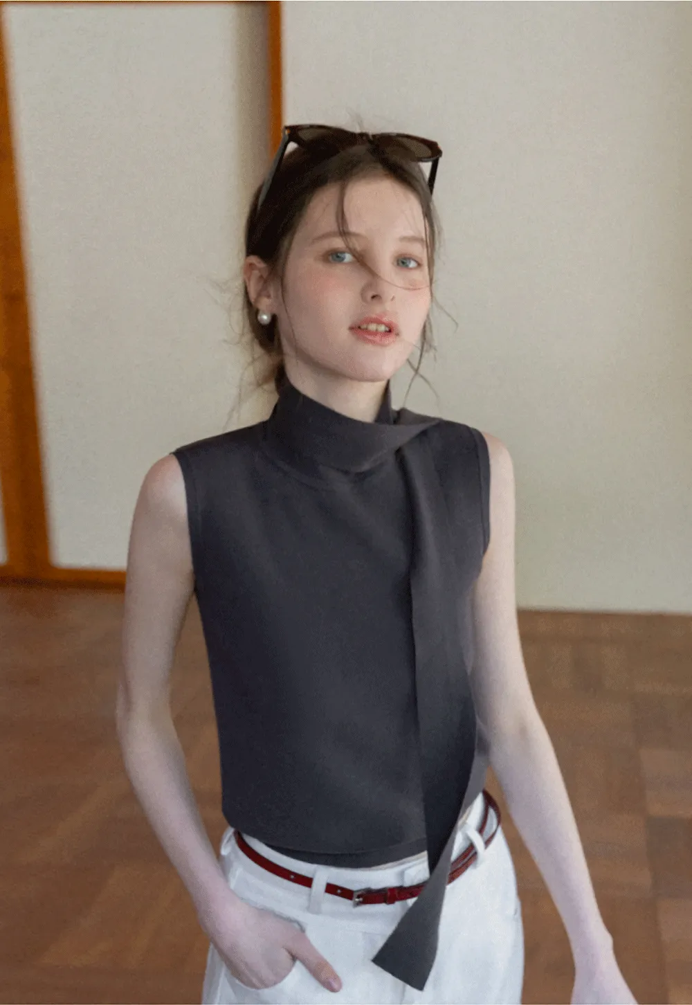 Sleeveless high neck knit top with side tie detail