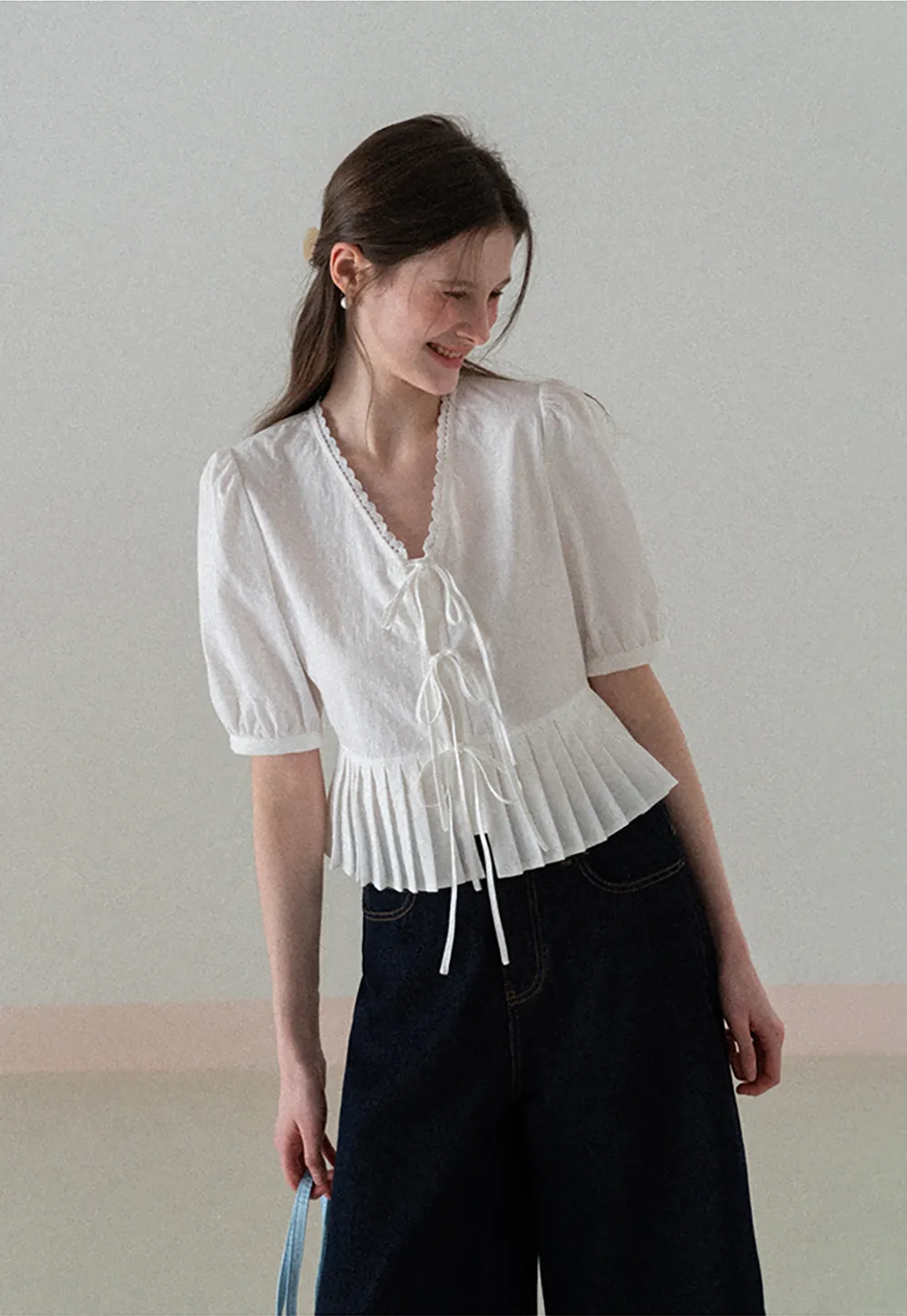 V neck short sleeve blouse with pleated hem and tie front