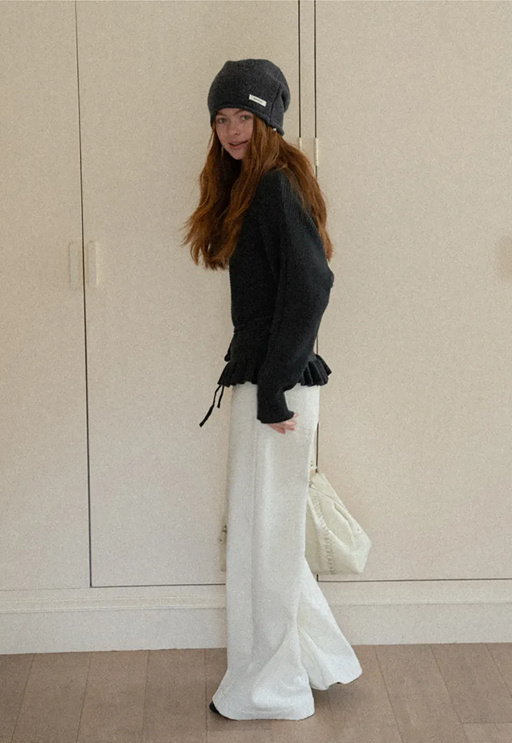 Ribbed knit sweater with tie back and flared hem design