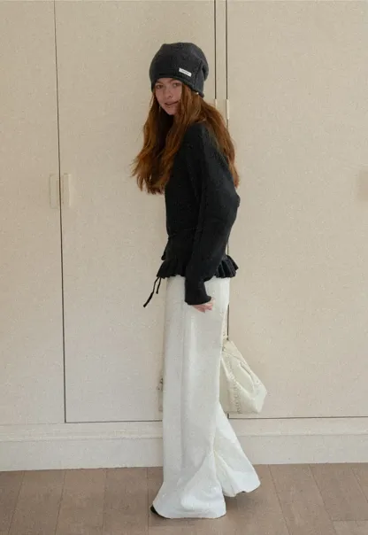 Ribbed knit sweater with tie back and flared hem design