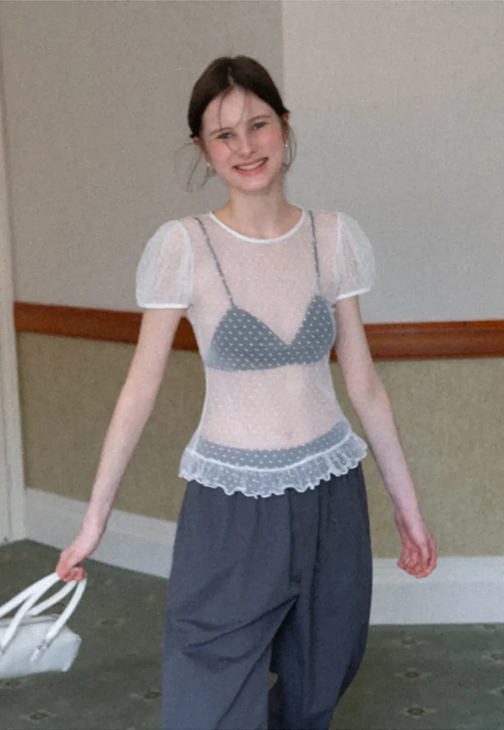 Sheer polka dot top with ruffled hem and puff sleeves