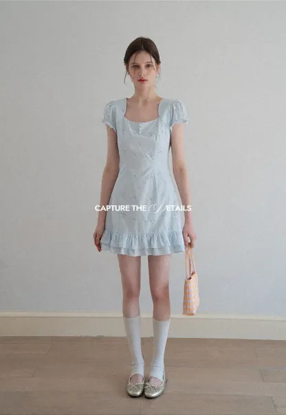 Eyelet dress with puff sleeves and ruffled hem