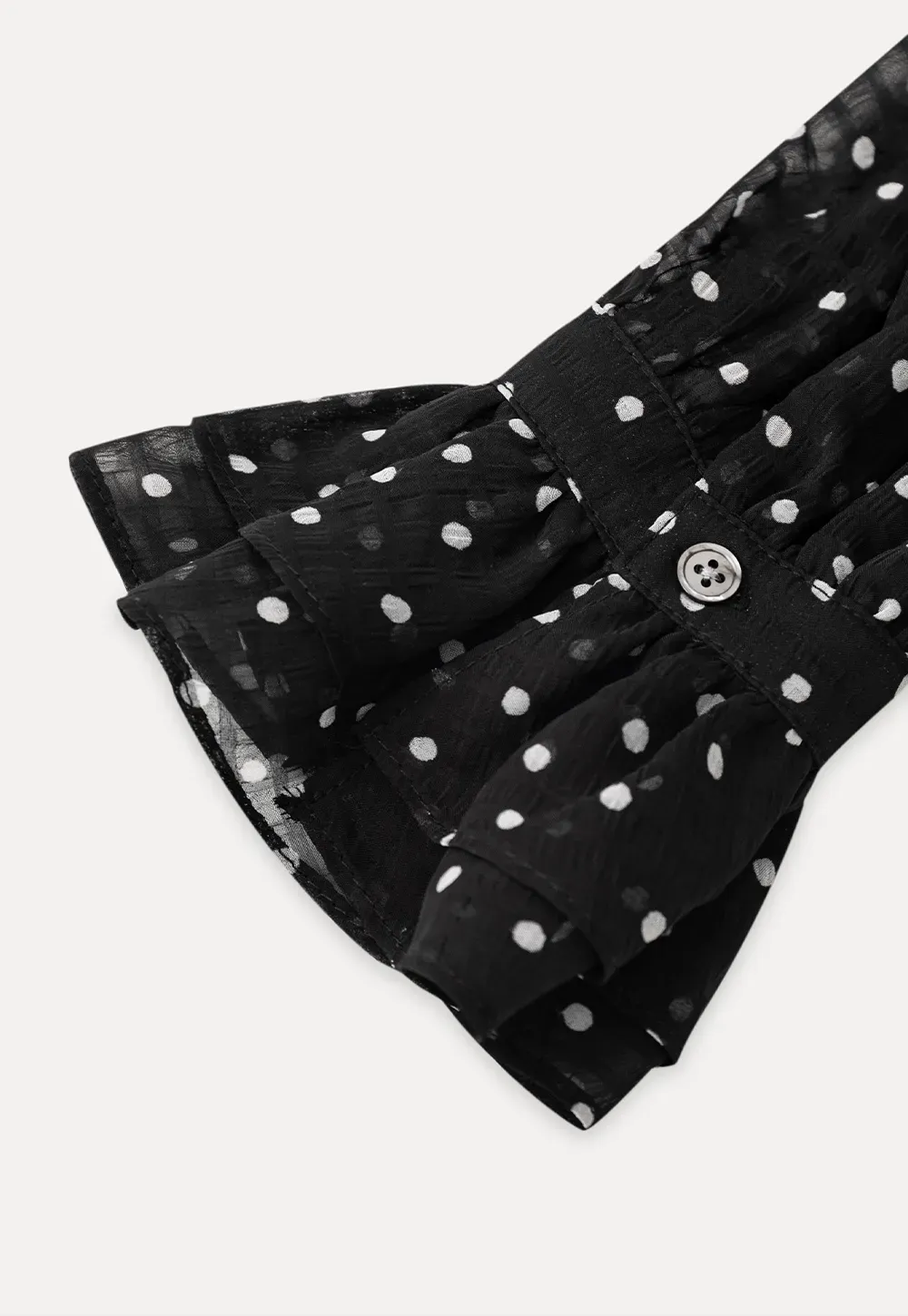 Sheer polka dot blouse with ruffled neckline and long sleeves