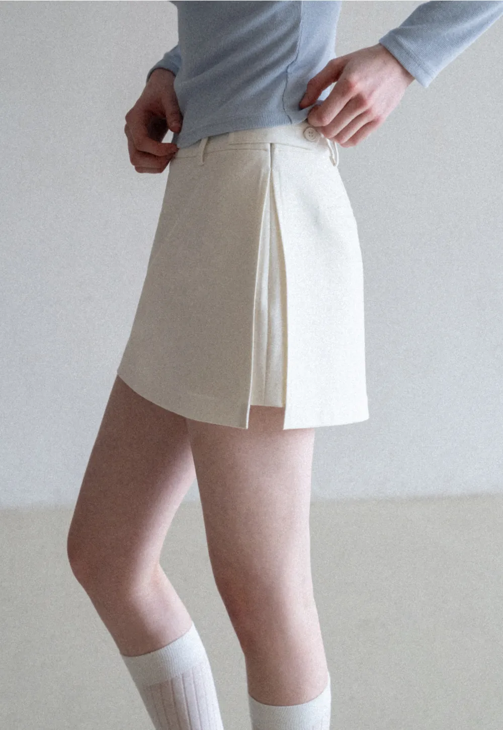 Elegant Pleated Mini Skirt with Asymmetrical Hem