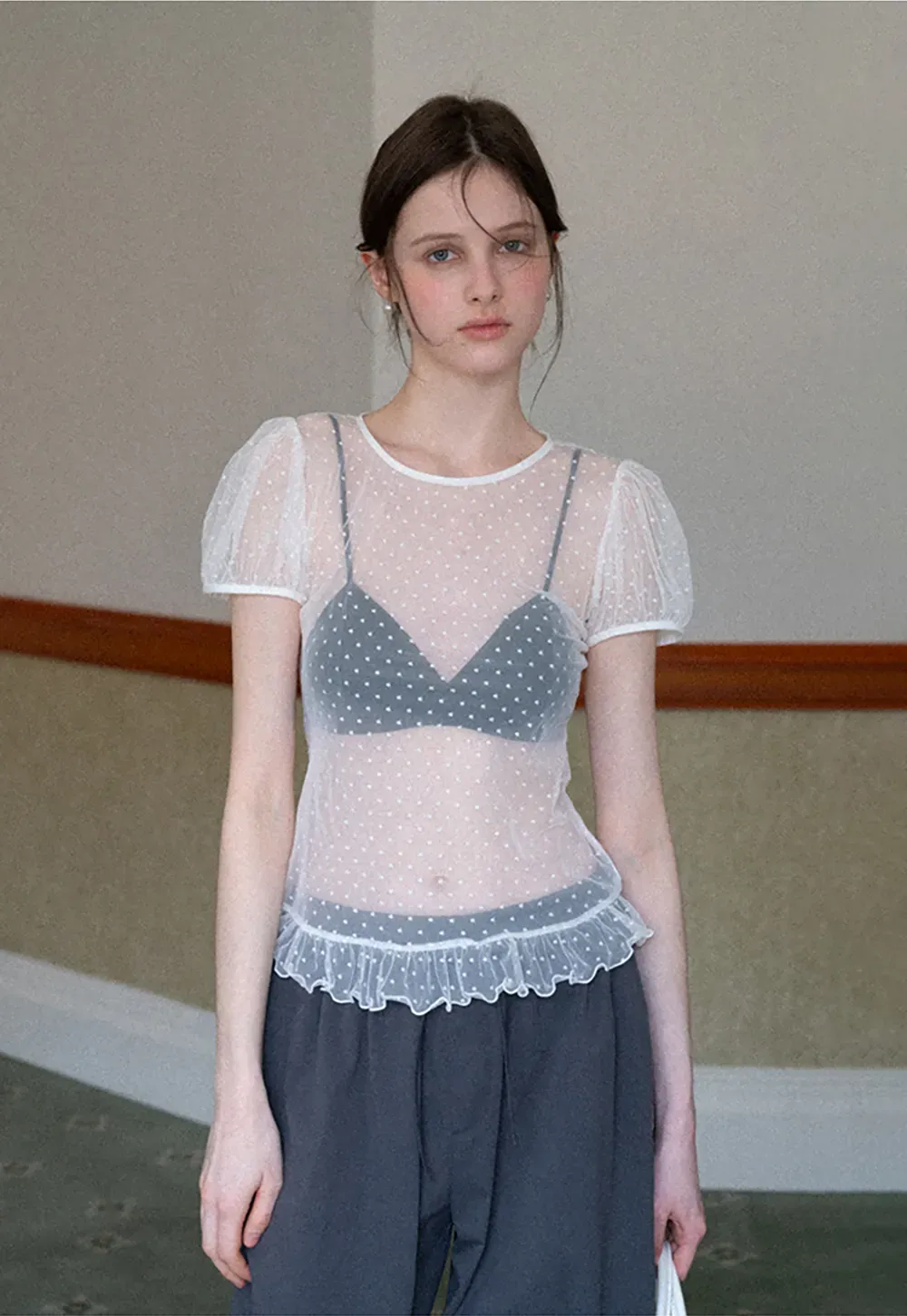 Sheer polka dot top with ruffled hem and puff sleeves