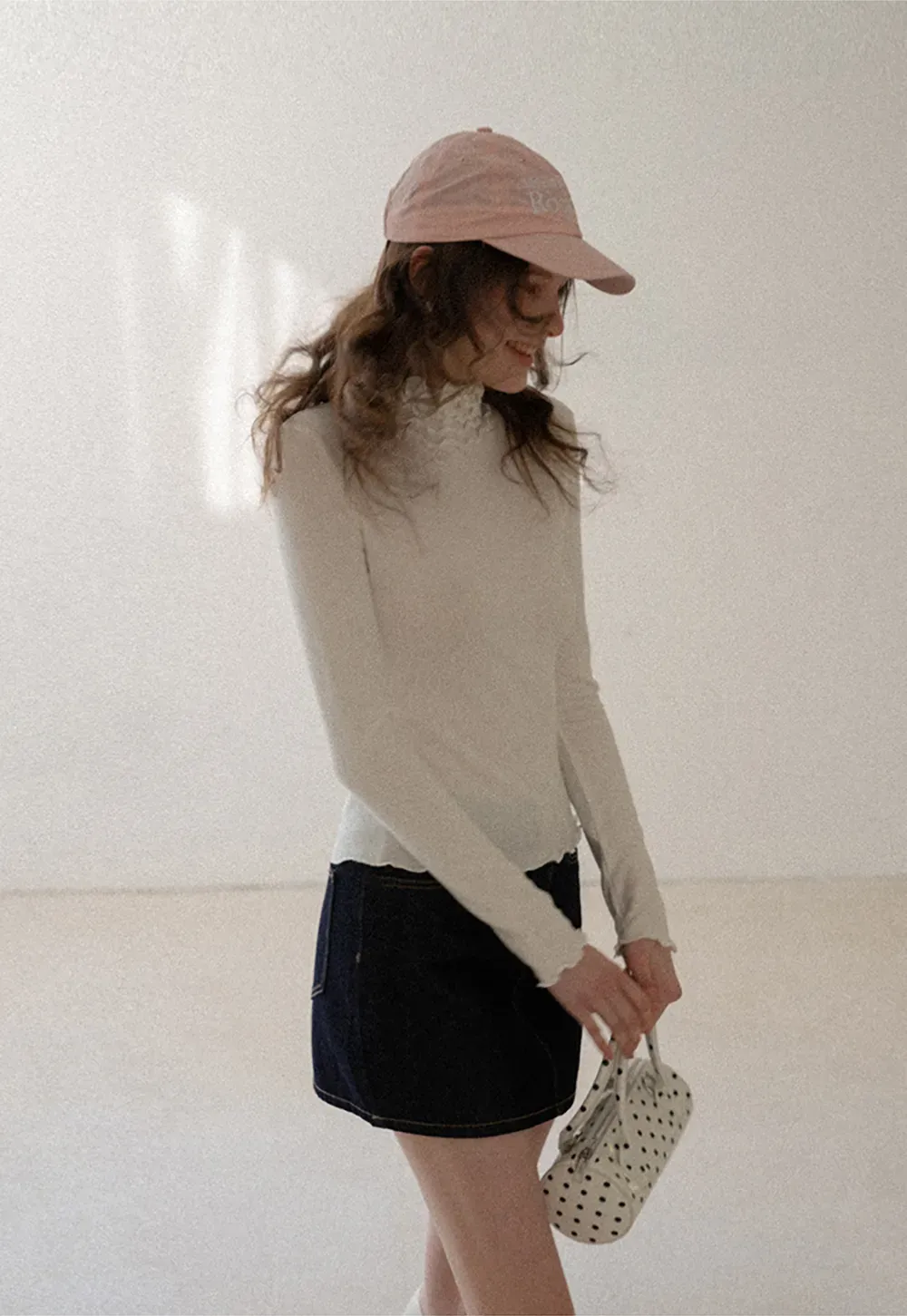 A-line denim skirt with front pocket design and adjustable waistband.