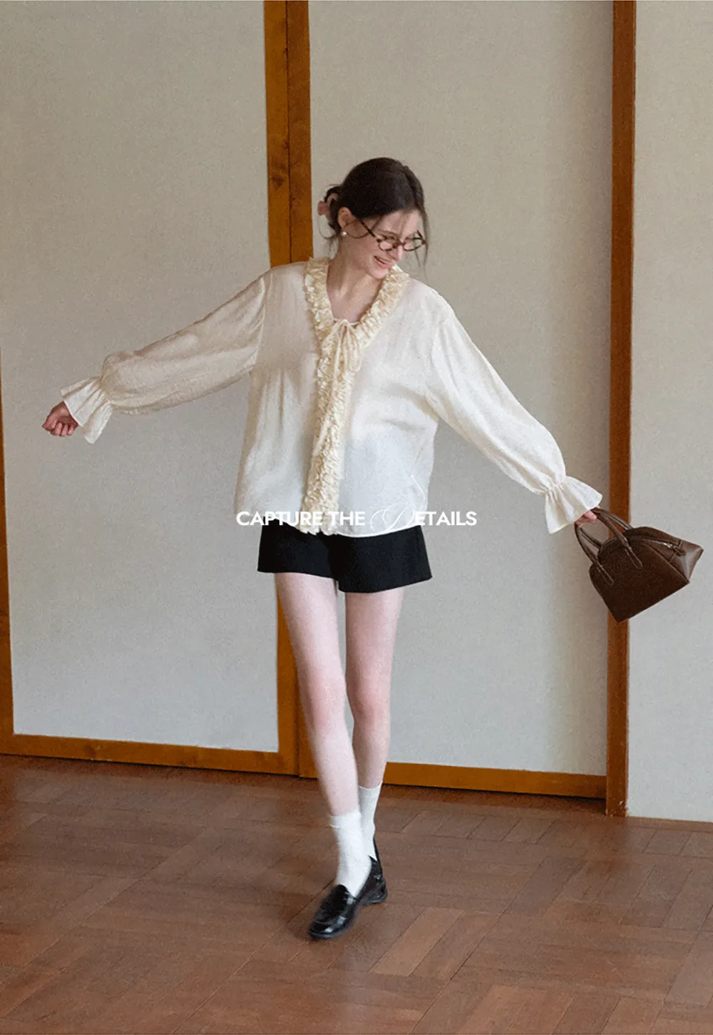 Long sleeve shirt with ruffled neckline and gathered cuffs