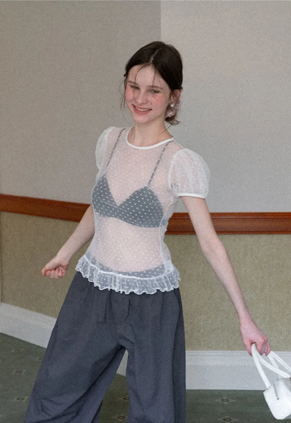 Sheer polka dot top with ruffled hem and puff sleeves