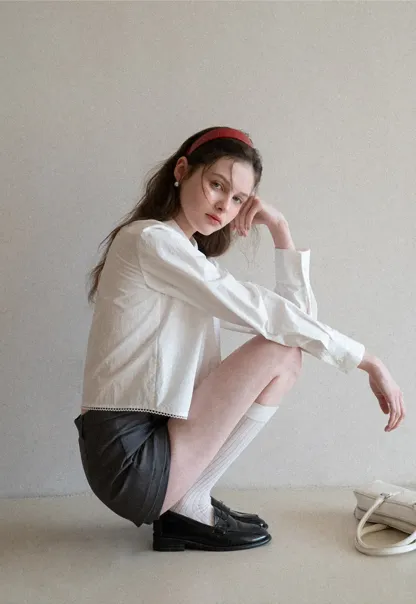 Long sleeve button front shirt with scalloped hem