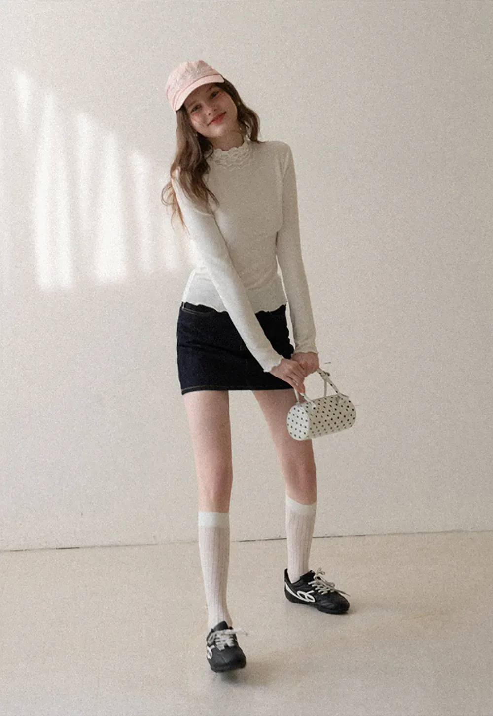 A-line denim skirt with front pocket design and adjustable waistband.