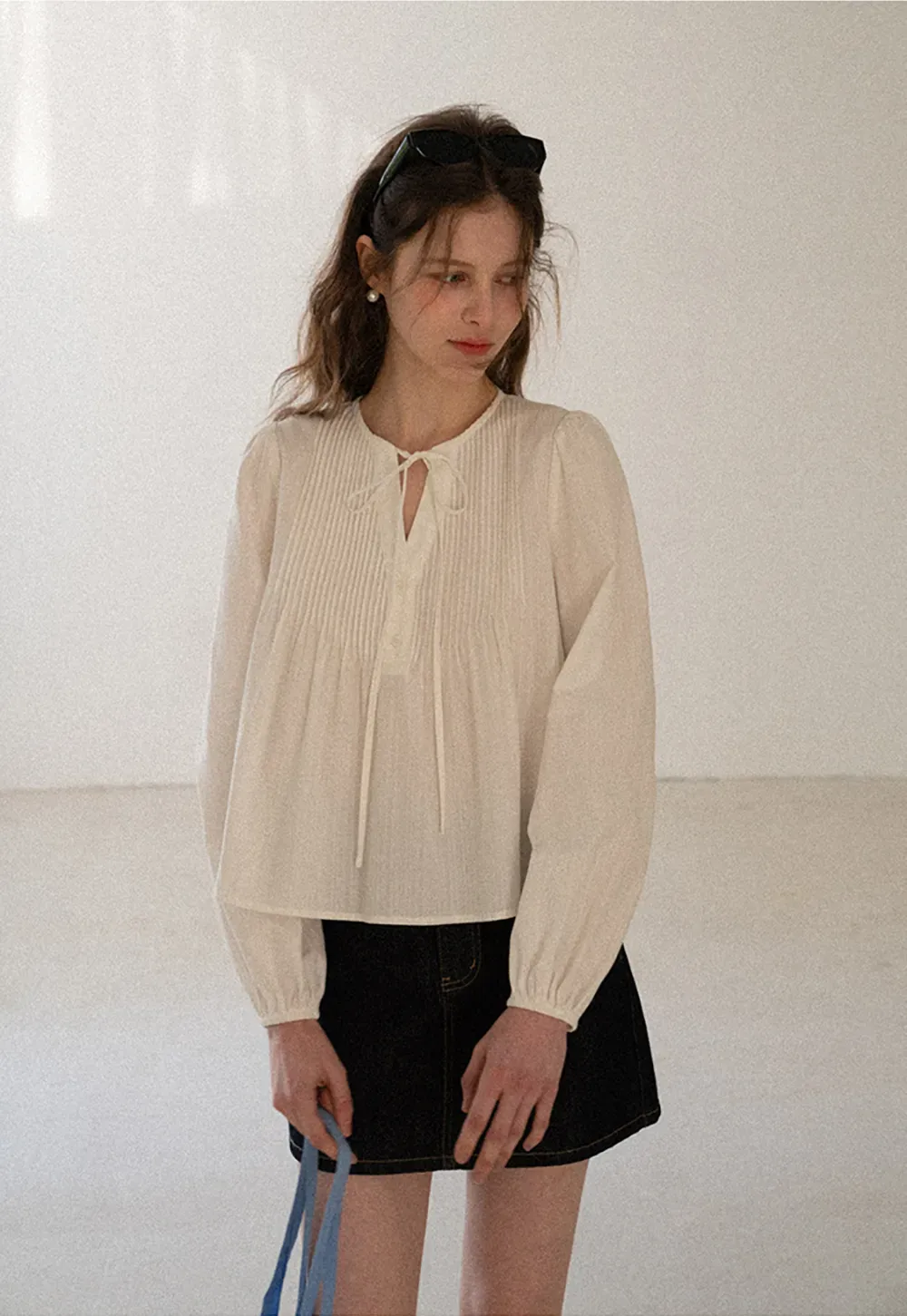 A-line denim skirt with front pocket design and adjustable waistband.