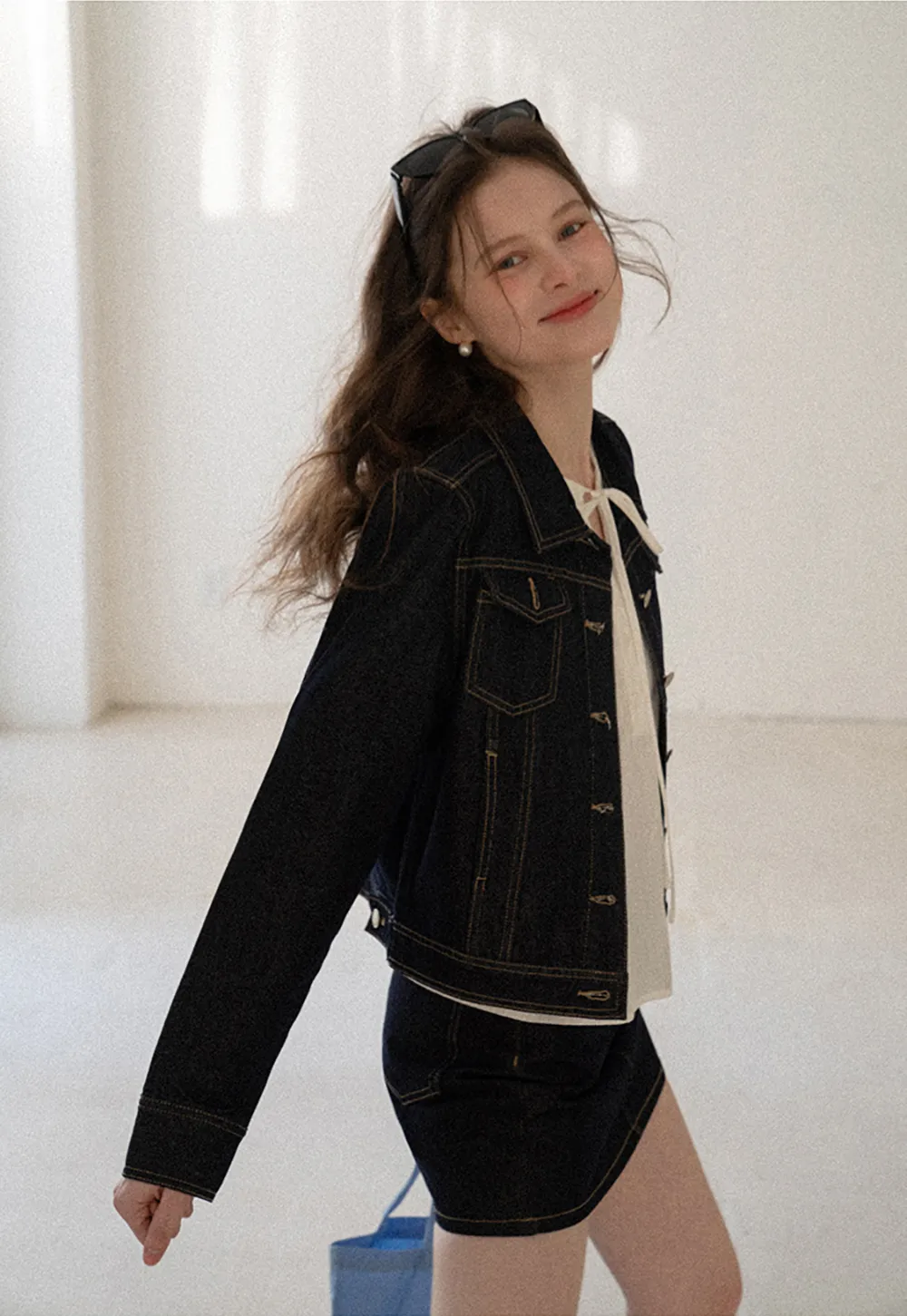 A-line denim skirt with front pocket design and adjustable waistband.