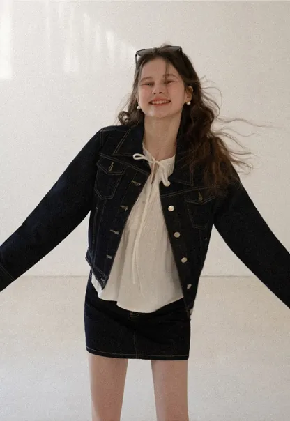 A-line denim skirt with front pocket design and adjustable waistband.