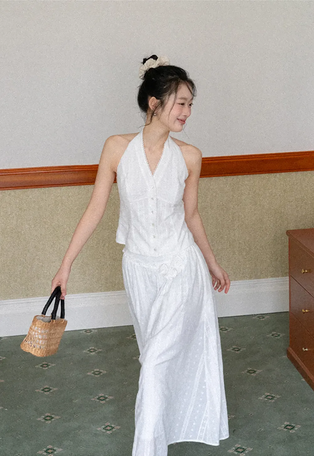 Halter neck sleeveless top with buttons and pleated skirt