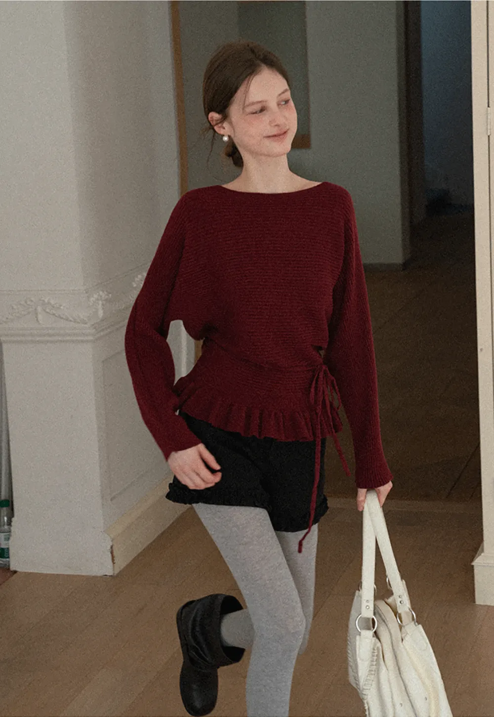 Ribbed knit sweater with tie back and flared hem design