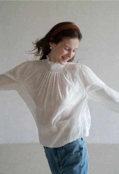 Elegant High Neck Blouse with Ruffled Cuffs and Hem