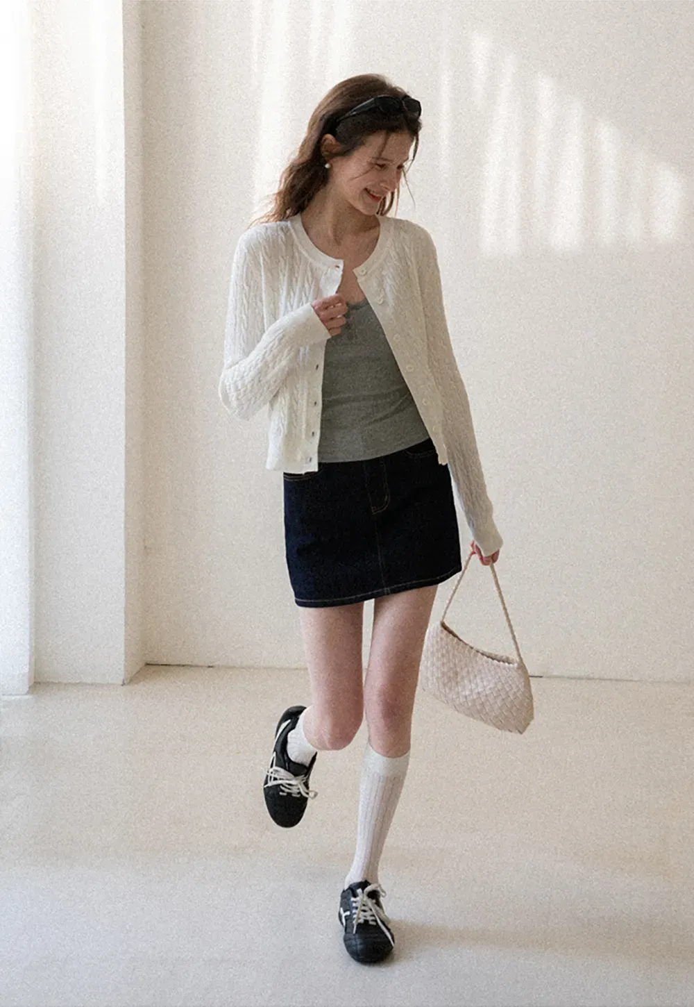 A-line denim skirt with front pocket design and adjustable waistband.