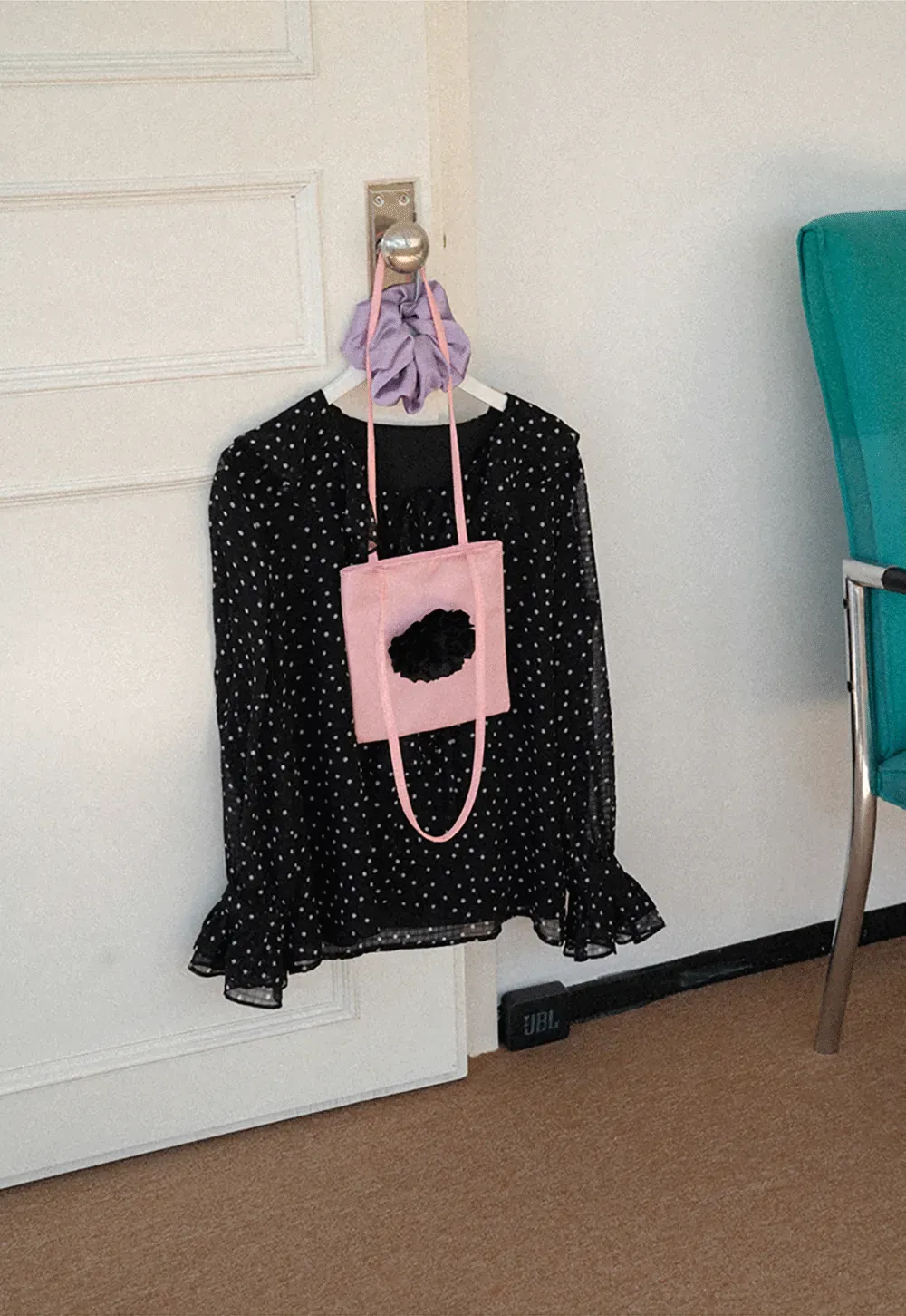 Sheer polka dot blouse with ruffled neckline and long sleeves