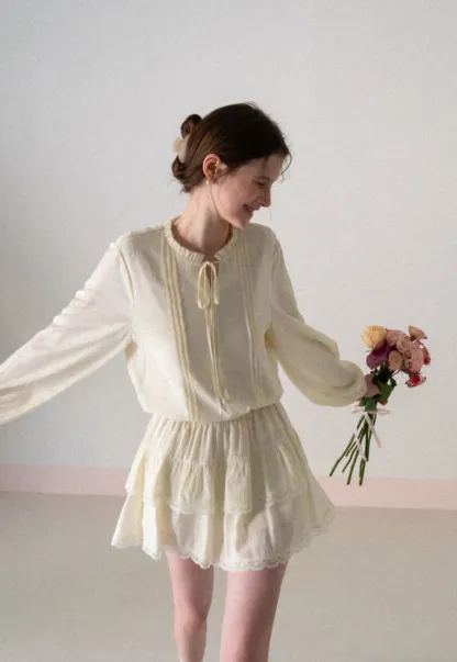 Shirt with ruffled collar and tie front layered skirt