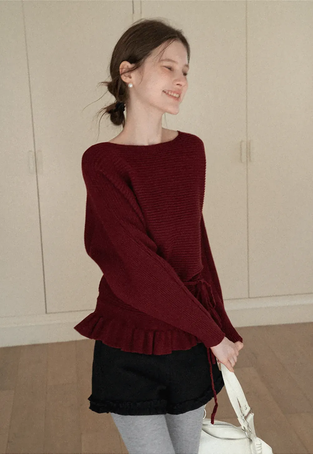 Ribbed knit sweater with tie back and flared hem design