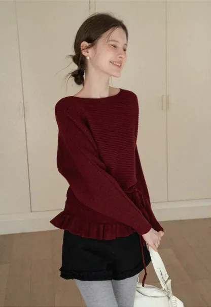 Ribbed knit sweater with tie back and flared hem design