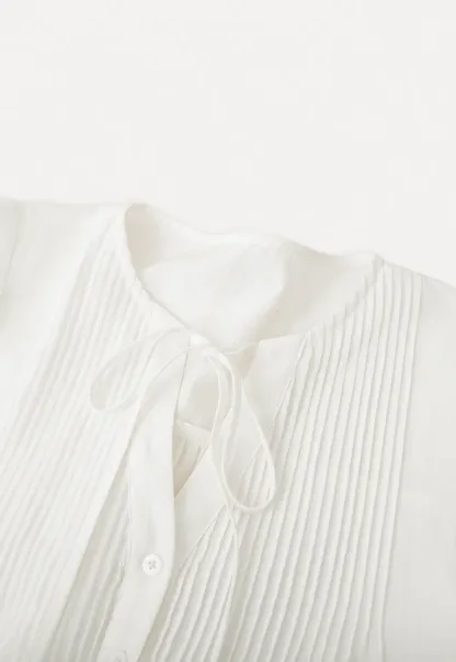 Pleated blouse with tie neck and long sleeves