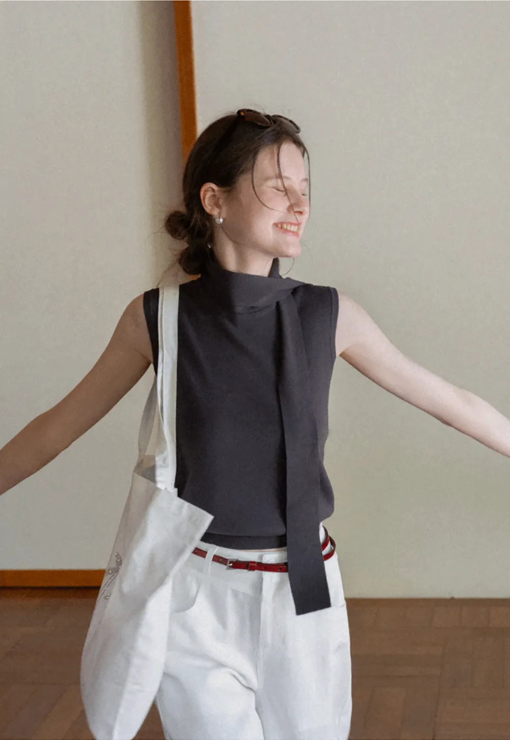 Sleeveless high neck knit top with side tie detail